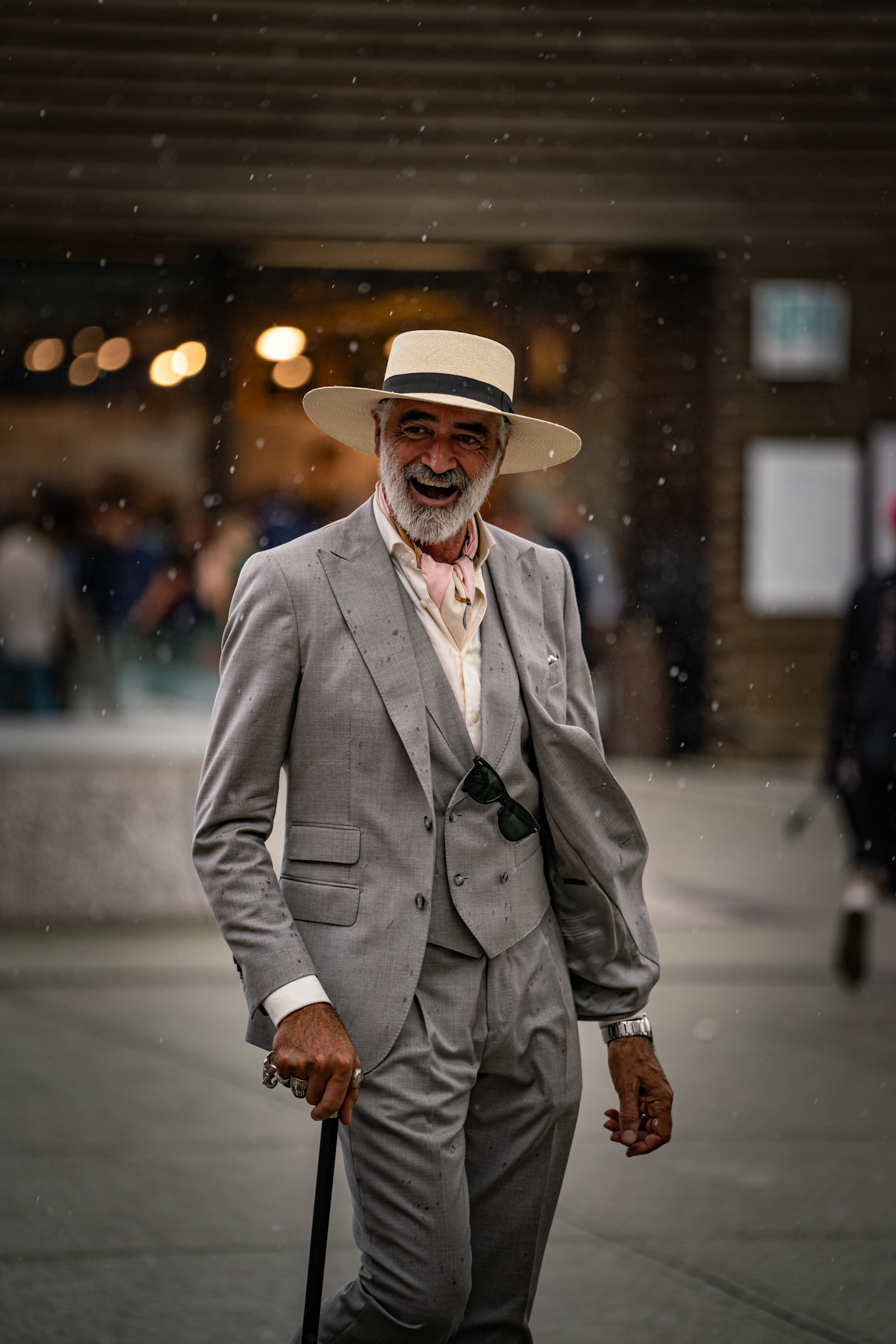 Pitti Uomo 104 - man in grey suit in the rain