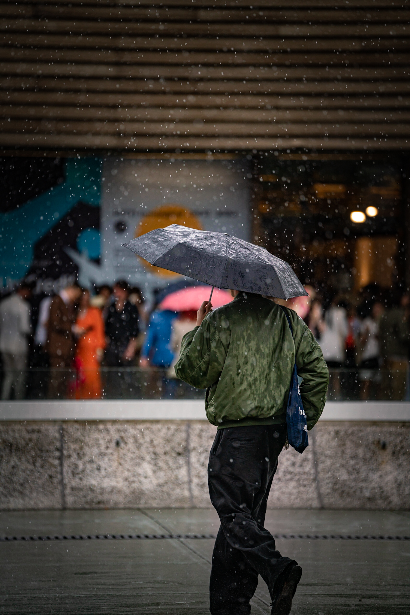 Pitti Uomo 104 - man walking in rain