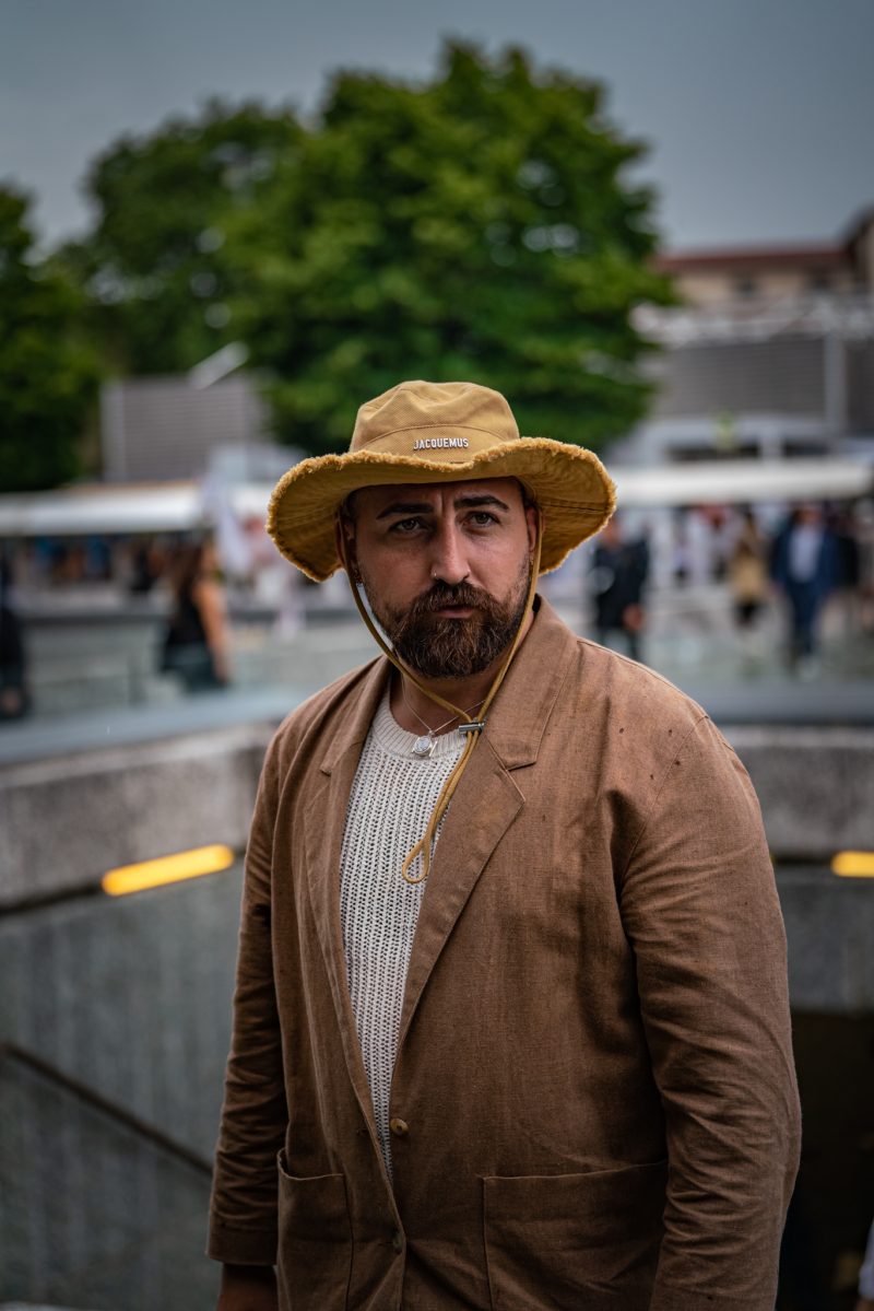 Man in yellow bucket hat with brown linen jacket
