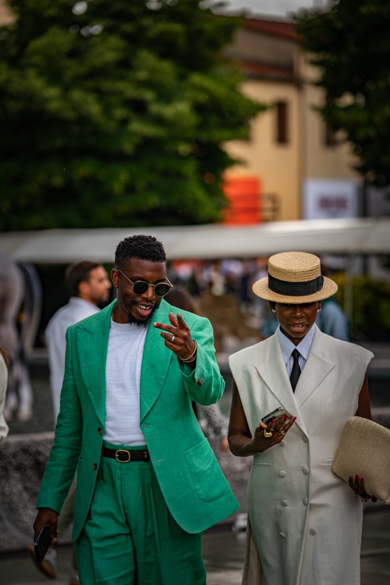 Man in green suit and woman in cream suit-dress
